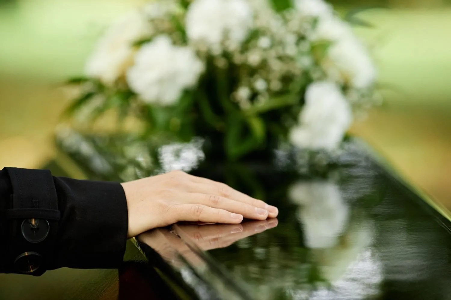 Three pairs of hands resting together in support